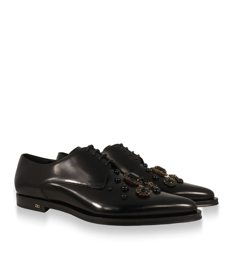 Dolce & Gabbana Derby Schuhe Paar in Schrägansicht mit Nieten und Kristallapplikationen