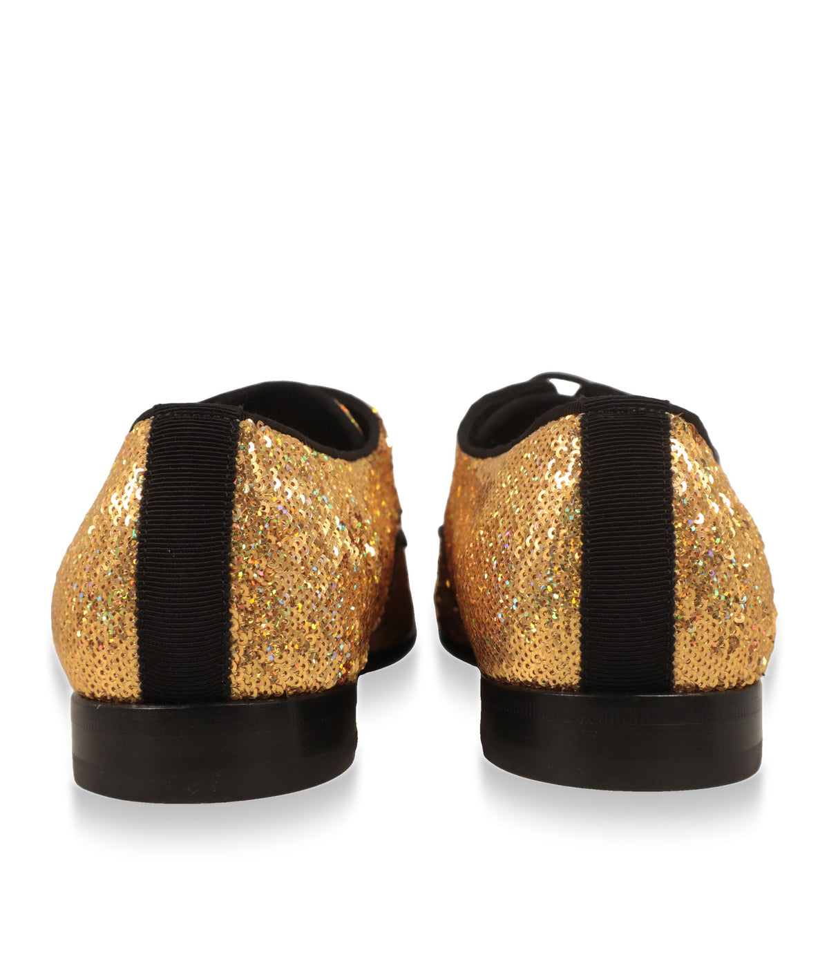 Fersenansicht der goldenen Derby Schuhe mit schwarzem Ripsband und flacher Sohle